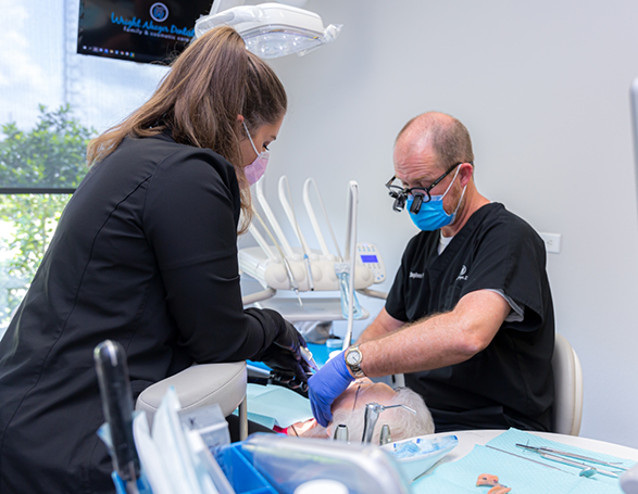 Dentist and assistant treating a patient