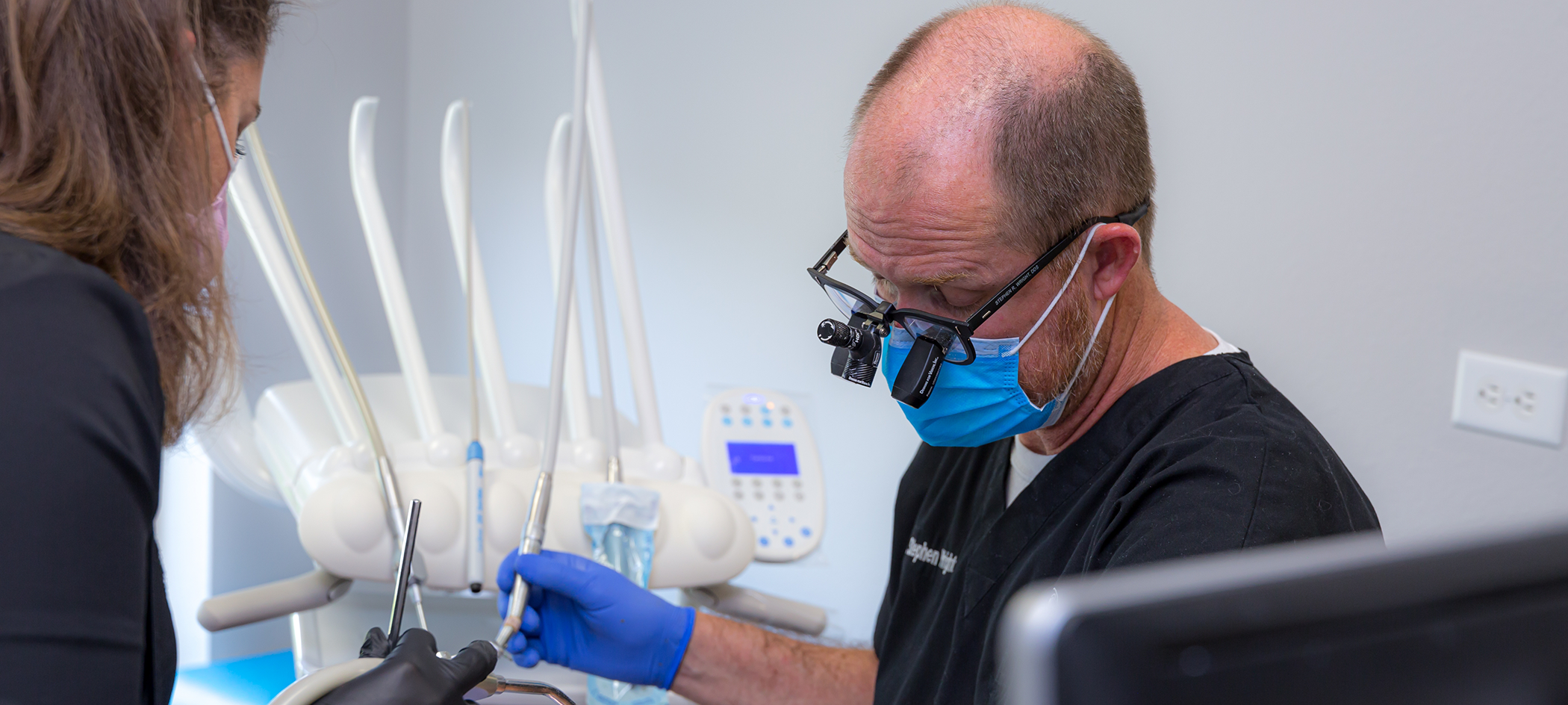 College Station dentist wearing dental binoculars while treating a patient