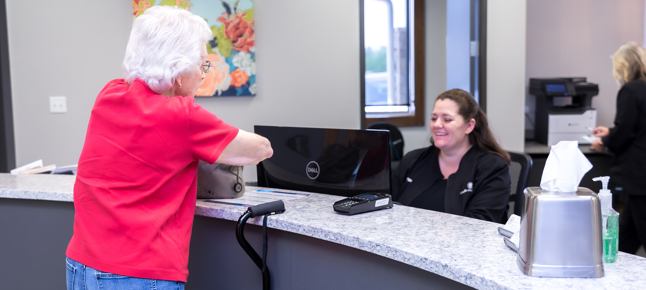 Dental patient checking in at the front desk