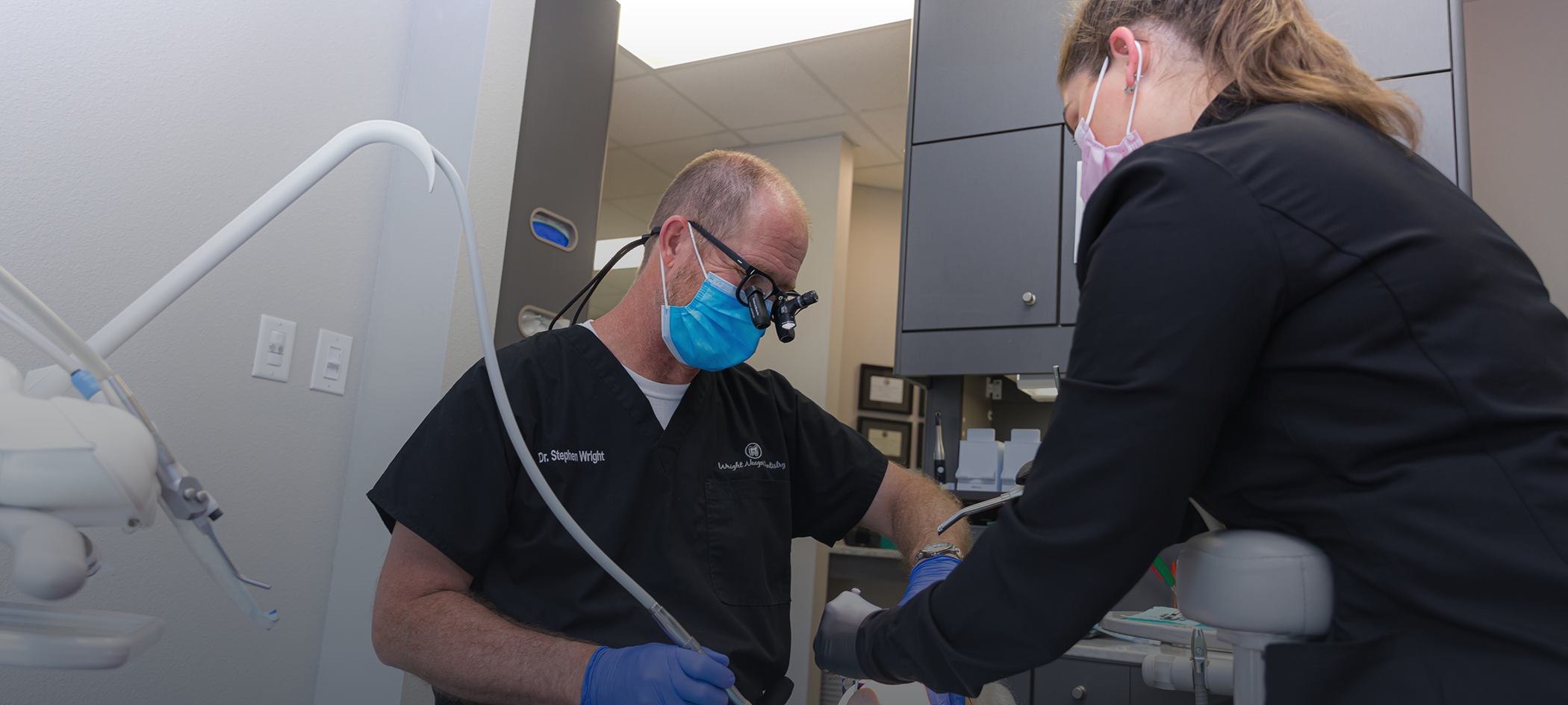 Dentist and assistant providing a patient with a dental service