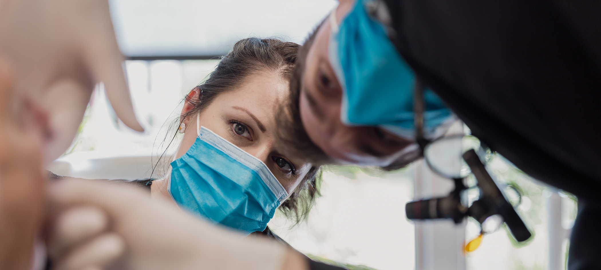Dentist and assistant examining a patient's mouth